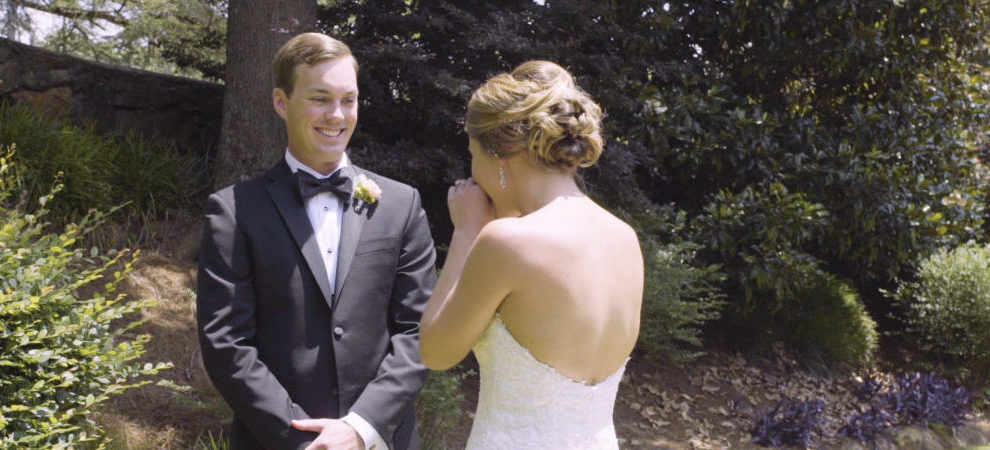 groom smiles when he sees his bride for the first time