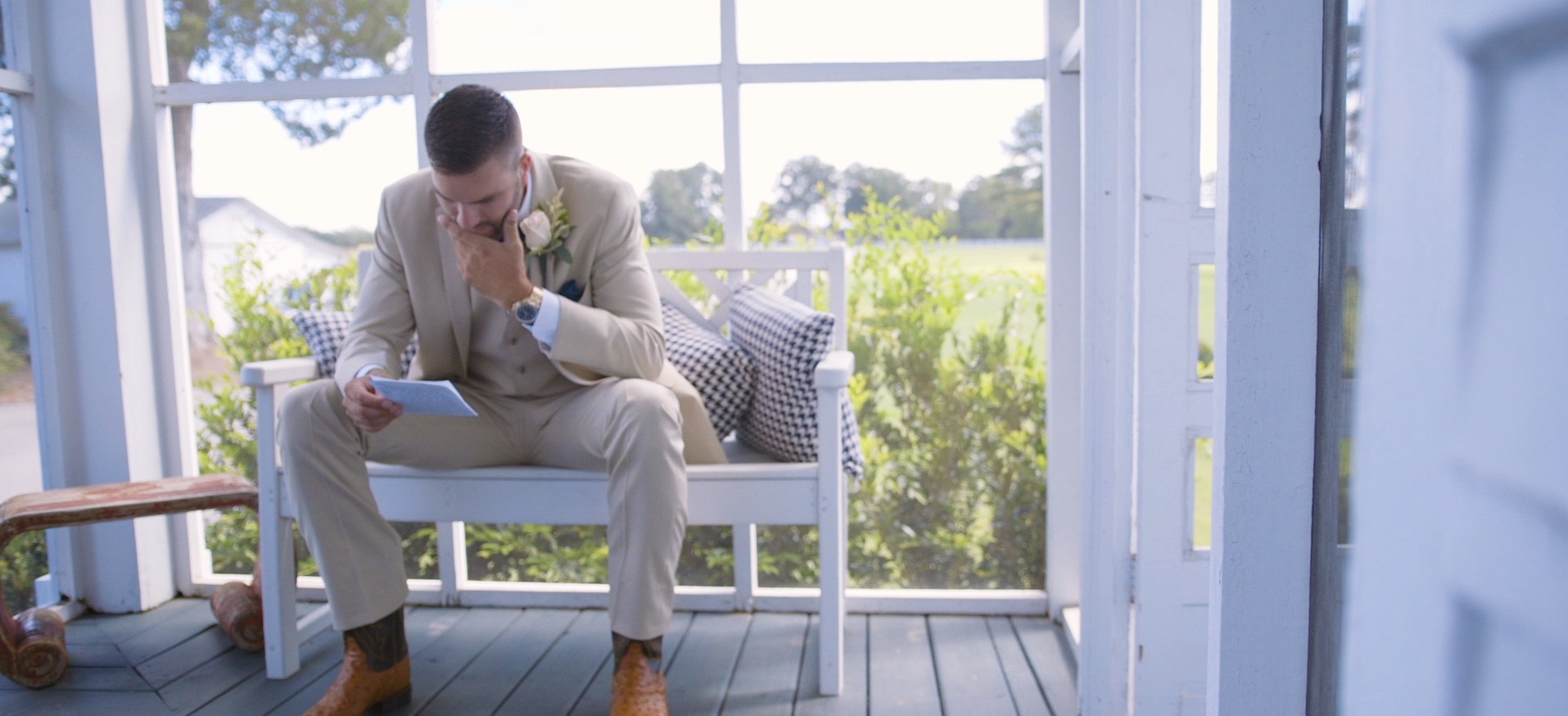 Groom reading letter from bride before marriage hire a wedding videographer
