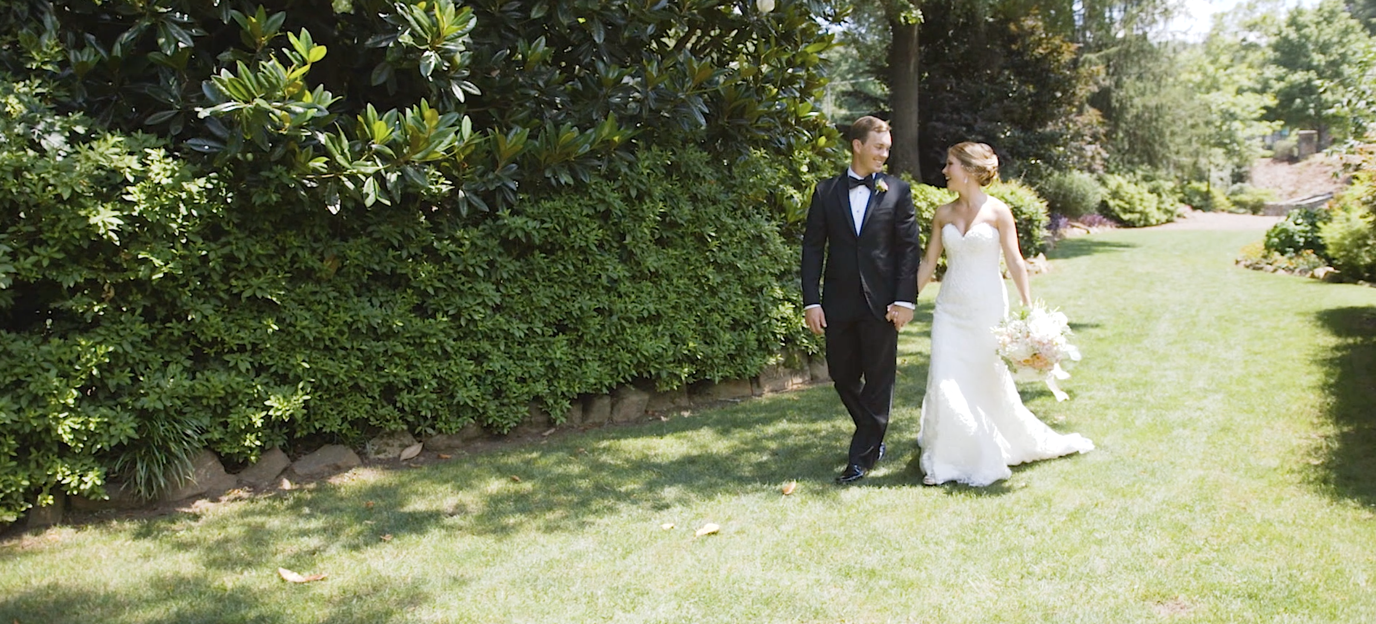 Bride and groom walking together hire a wedding videographer