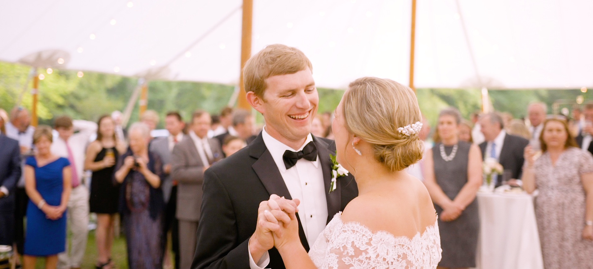 bride and groom dance under a sperry tent