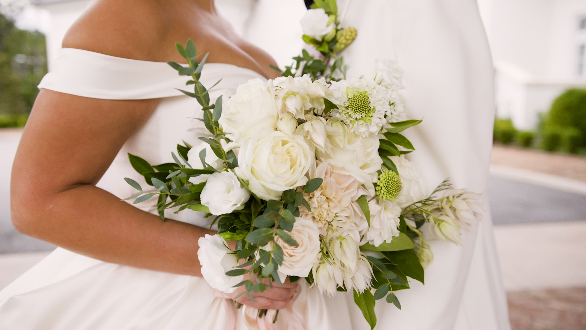 a bride holds her flowers at Greenville Country Club