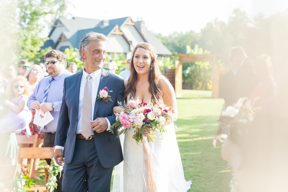 dad walks his daughter down the aisle at her wedding